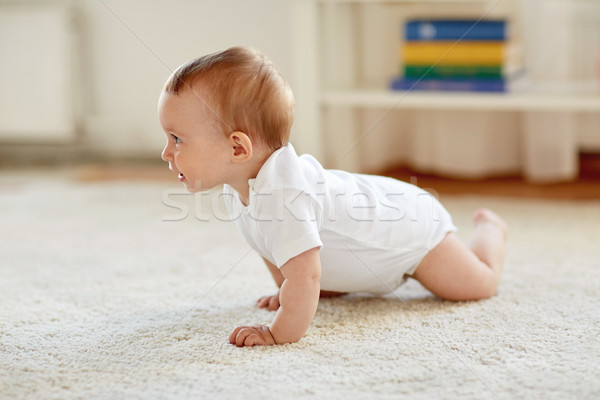 little baby in diaper crawling on floor at home Stock photo © dolgachov
