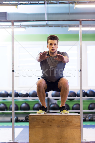 Stock photo: young man doing box jumps exercise in gym