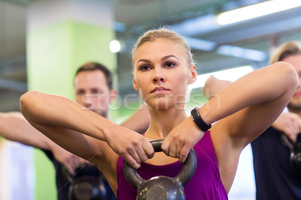 Stock photo: group of people with kettlebells exercising in gym