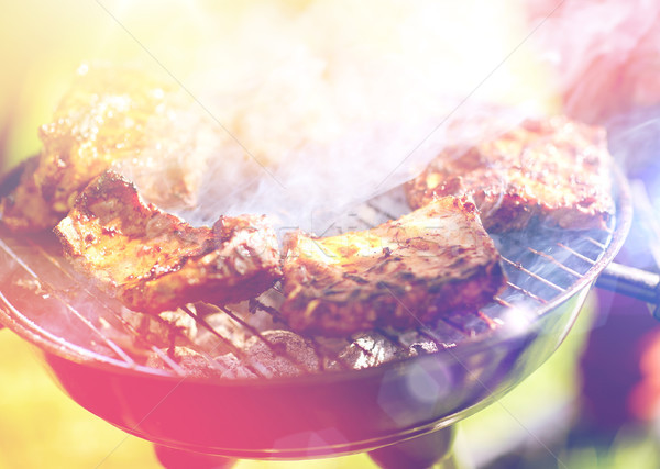 meat cooking on barbecue grill at summer party Stock photo © dolgachov