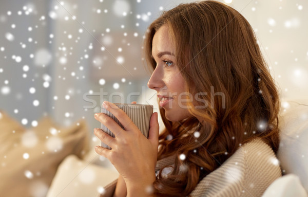 happy woman with cup of coffee in bed at home Stock photo © dolgachov