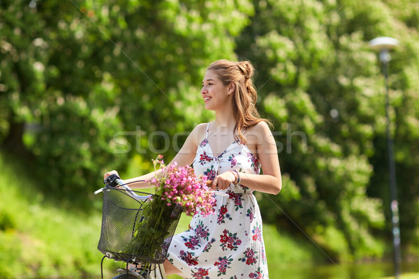 happy woman riding fixie bicycle in summer park Stock photo © dolgachov