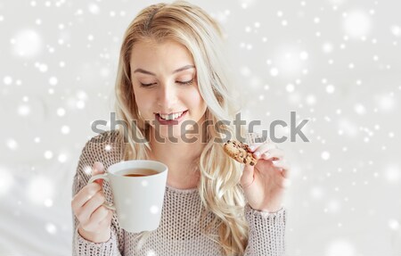 happy woman with cup of coffee in bed at home Stock photo © dolgachov