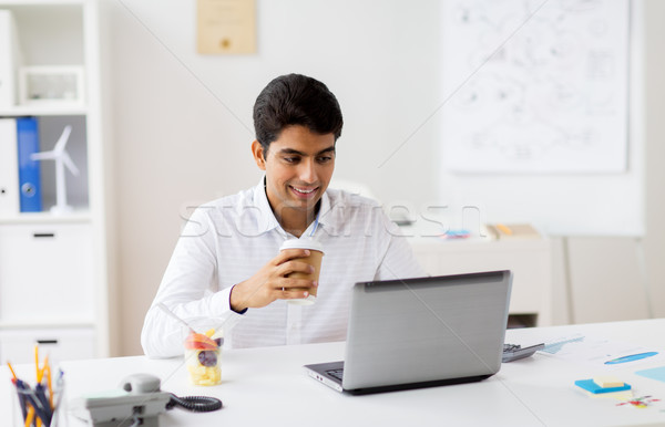 businessman with laptop drinking coffee at office Stock photo © dolgachov
