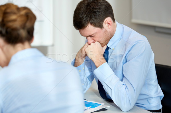 upset or anxious businessman with report at office Stock photo © dolgachov
