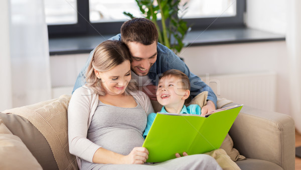 happy family reading book at home Stock photo © dolgachov