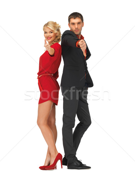 man and woman showing thumbs up, down Stock photo © dolgachov