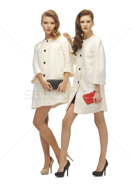 two teenage girls in white coats with clutches Stock photo © dolgachov