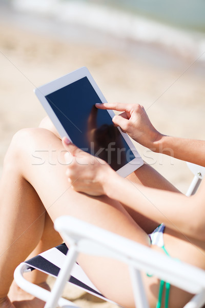 girl looking at tablet pc on the beach Stock photo © dolgachov