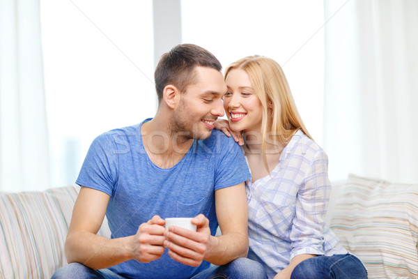 smiling man with cup of tea or coffee with wife Stock photo © dolgachov