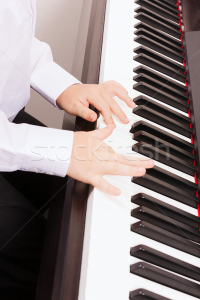 close up of child hands playing the piano Stock photo © dolgachov