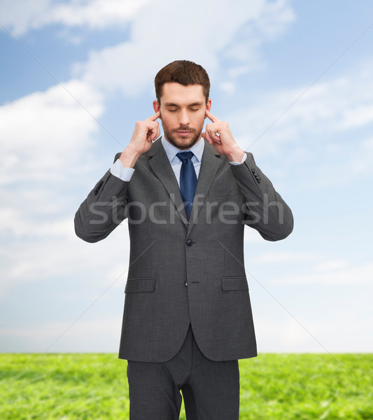 annoyed businessman covering ears with his hands Stock photo © dolgachov