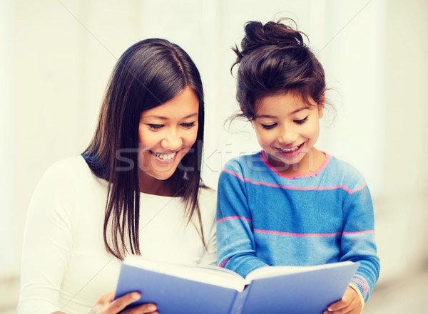 Stock photo: mother and daughter with book