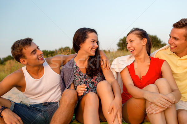 smiling friends in sunglasses on summer beach Stock photo © dolgachov