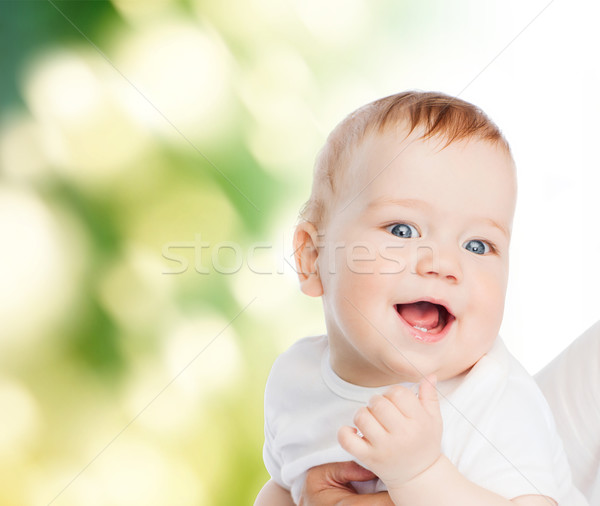Stock photo: close up of mother holding smiling baby