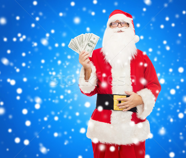 man in costume of santa claus with dollar money Stock photo © dolgachov