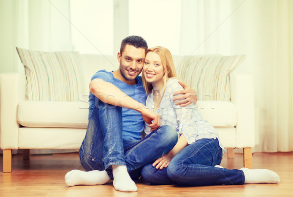 smiling happy couple at home Stock photo © dolgachov