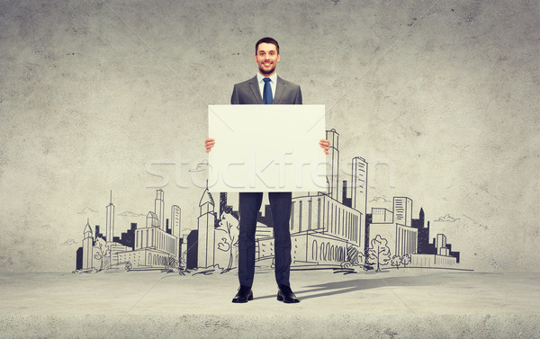 smiling businessman with white blank board Stock photo © dolgachov