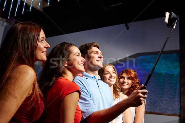 friends with smartphone taking selfie in club Stock photo © dolgachov