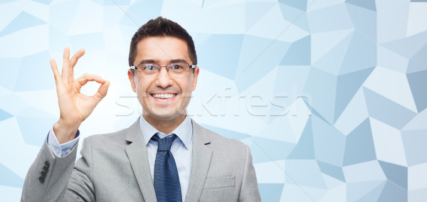happy smiling businessman in eyeglasses and suit Stock photo © dolgachov