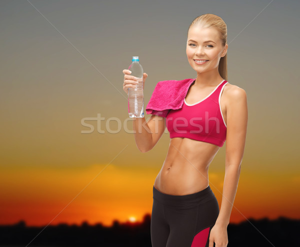 happy woman with water bottle and towel outdoors Stock photo © dolgachov