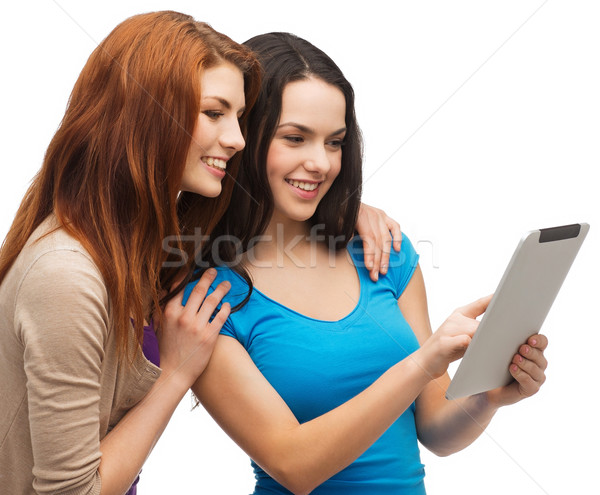 two smiling teenagers with tablet pc computer Stock photo © dolgachov