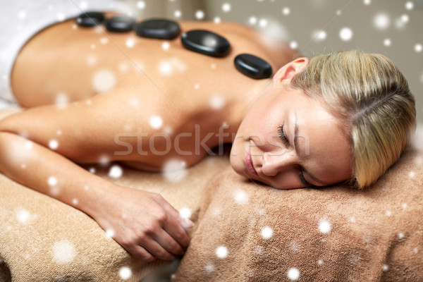 close up of woman having hot stone massage in spa Stock photo © dolgachov