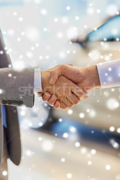 close up of male handshake in auto show or salon Stock photo © dolgachov
