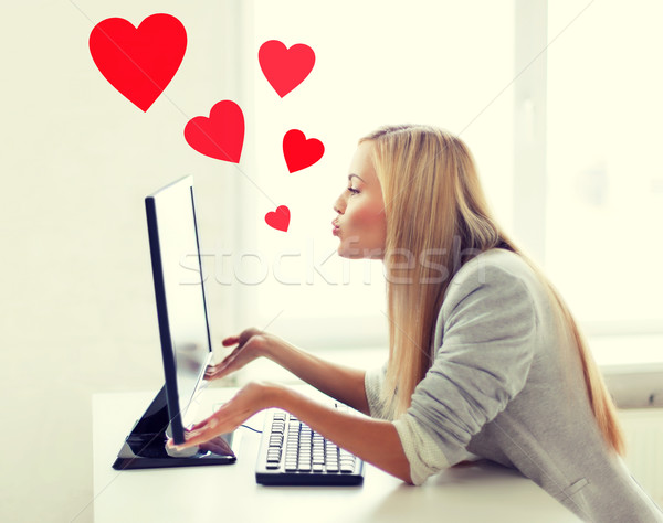 Stock photo: woman sending kisses with computer monitor