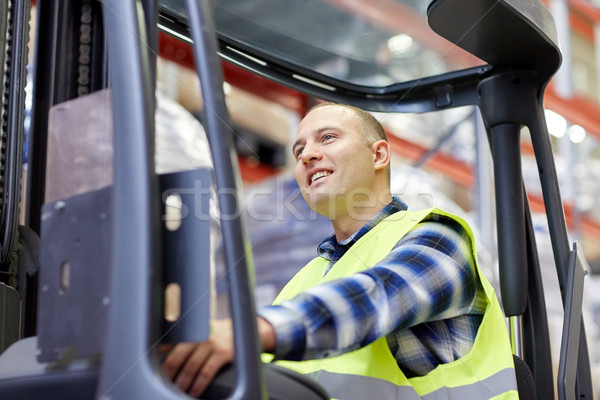 man operating forklift loader at warehouse Stock photo © dolgachov