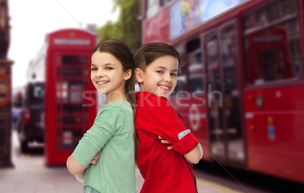 happy boy and girl standing over london city Stock photo © dolgachov