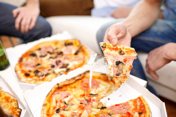 close up of friends with beer and pizza at home Stock photo © dolgachov