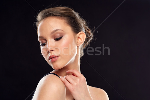 beautiful young asian woman over black background Stock photo © dolgachov