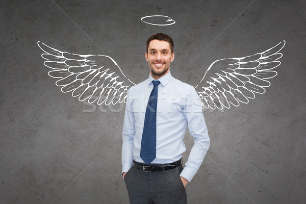 smiling businessman with angel wings and nimbus Stock photo © dolgachov