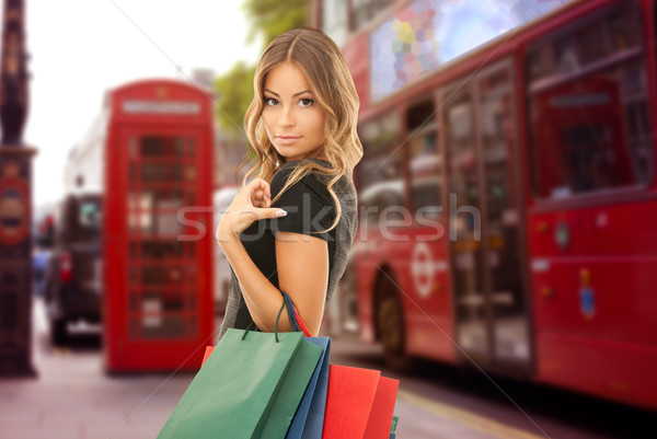 woman with shopping bags over london city street Stock photo © dolgachov