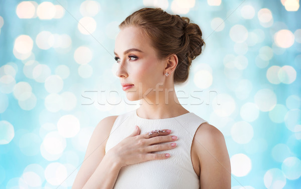 Stock photo: smiling woman in white dress with diamond jewelry