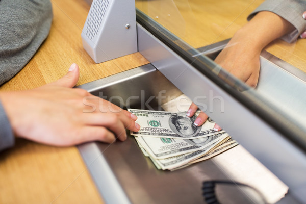 clerk giving cash money to customer at bank office Stock photo © dolgachov