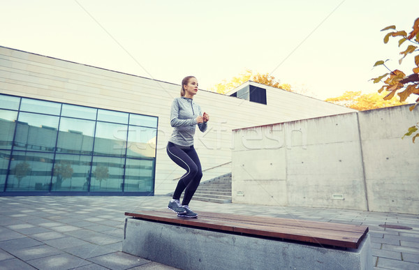 woman exercising on bench outdoors Stock photo © dolgachov