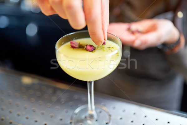 bartender decorating cocktail in glass at bar Stock photo © dolgachov