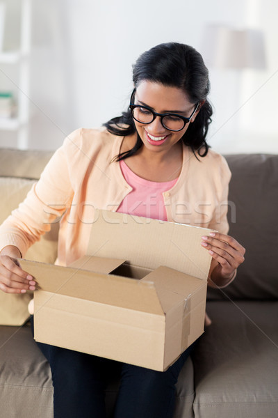 happy young indian woman with parcel box at home Stock photo © dolgachov