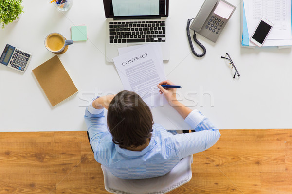 Stock photo: businesswoman signing contract document at office