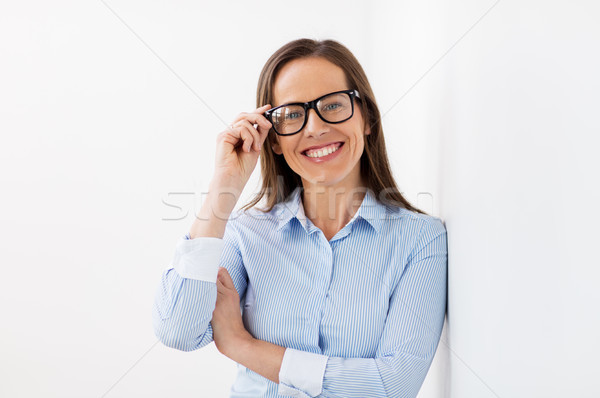 Stock photo: happy smiling middle aged woman in glasses