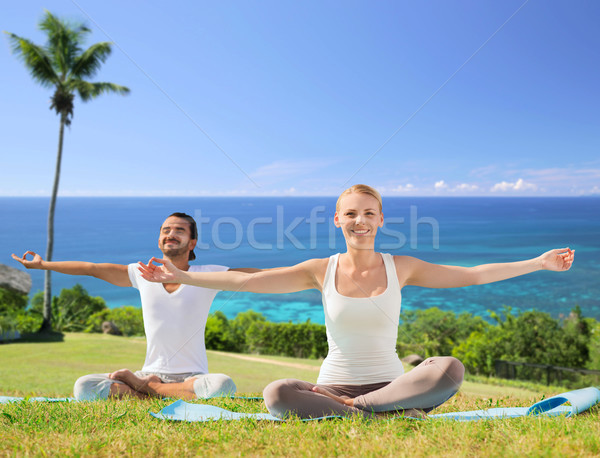 couple doing yoga in lotus pose outdoors Stock photo © dolgachov