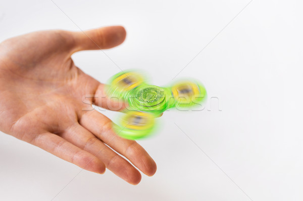 close up of hand playing with fidget spinner Stock photo © dolgachov