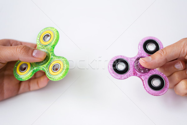 close up of two hands playing with fidget spinners Stock photo © dolgachov