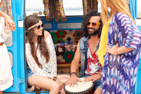 happy hippie friends playing music in minivan Stock photo © dolgachov