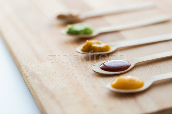 vegetable or fruit puree or baby food in spoons Stock photo © dolgachov
