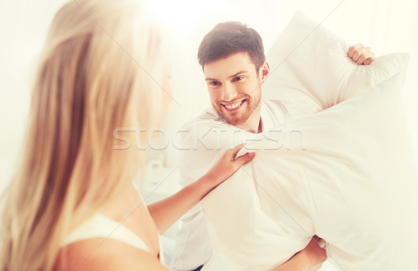 [[stock_photo]]: Heureux · couple · bataille · d'oreillers · lit · maison · personnes