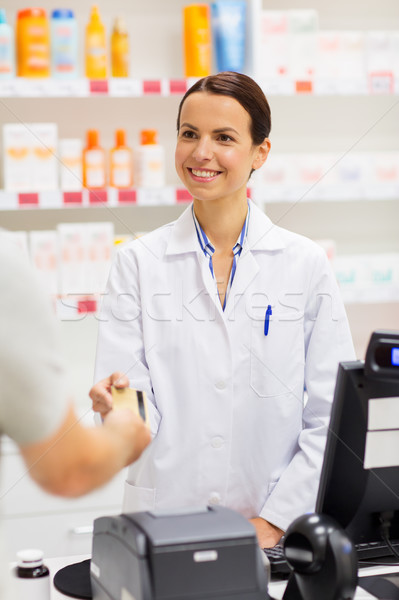 apothecary taking credit card at pharmacy cashbox Stock photo © dolgachov