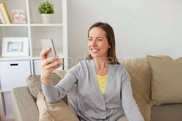 happy woman taking selfie by smartphone at home Stock photo © dolgachov